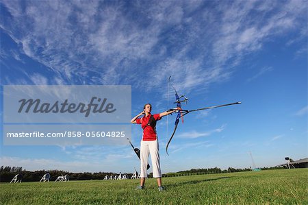 Young Female Archer Aiming at Target