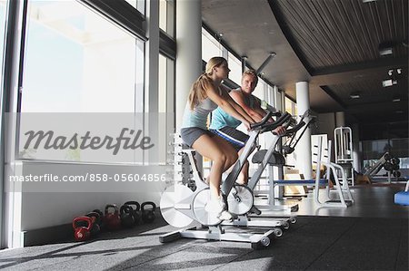 Young Couples Spinning on Exercise Bikes