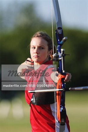 Young Female Archer Aiming at Target