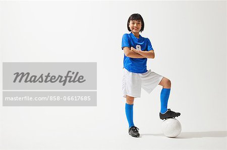 Girl Posing In Soccer Uniform With Ball