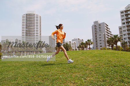 Woman Running On Grass