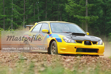 Rally car racing on dirt track