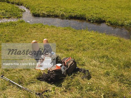 Hiker sleeping by curving river