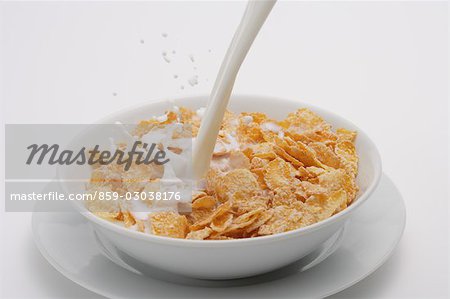 pouring milk into cereal