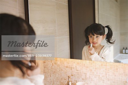 Little Girl Trying to Apply Makeup
