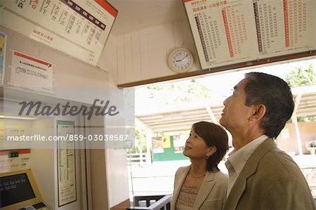 Couple looking up at the information board