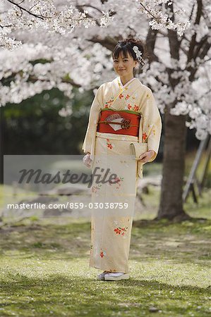 Woman in Kimono Standing Holding Clutch Purse