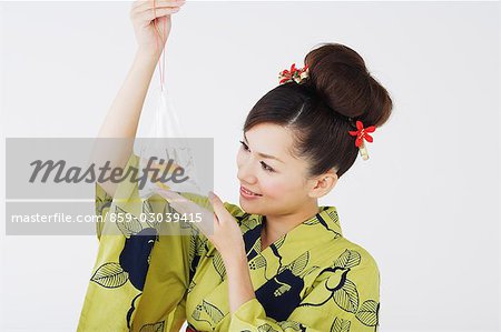 Woman Holding Goldfish Packed in Bag