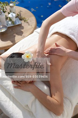 Hands massaging the back of a woman