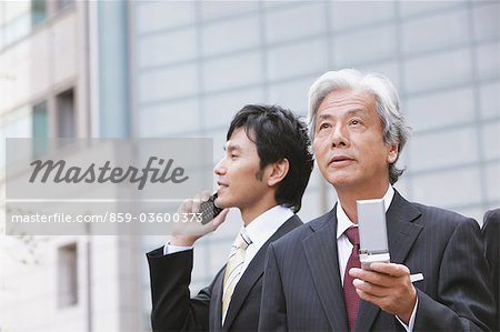 Businessmen Talking On The Phone