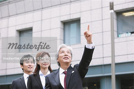 Businessman And Businesswoman Looking Up