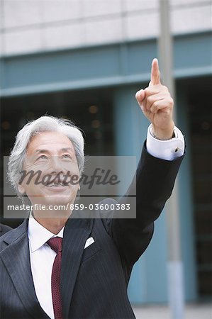 Executive Businessman Pointing With His Index Finger