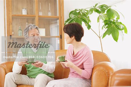 Senior Couple Relaxing In Living Room