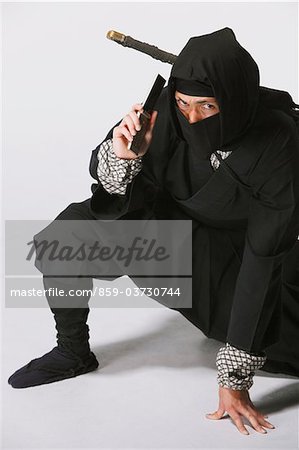 https://image1.masterfile.com/getImage/859-03730744em-ninja-using-mobile-stock-photo.jpg
