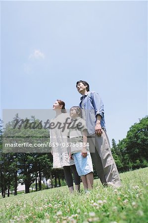 Japanese Family Standing In a Park