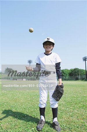 Baseball Player With Ball In Mid-Air