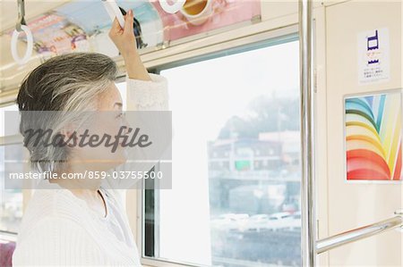 Senior adult woman traveling alone on a train