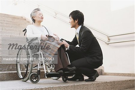 Young-Adult Man Talking With Elderly Woman