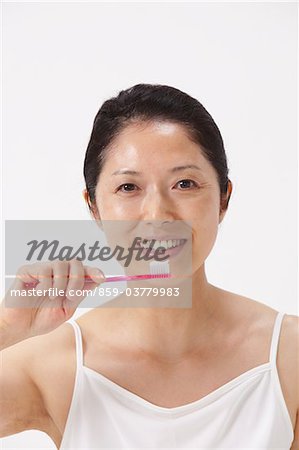 Portrait Of Woman Holding Toothbrush