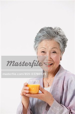 Senior Woman Holding Glass Of Juice