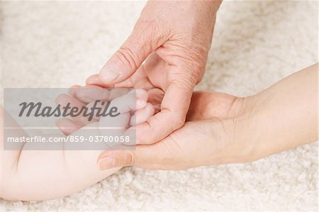 Hand Of A Baby On Woman's Hand