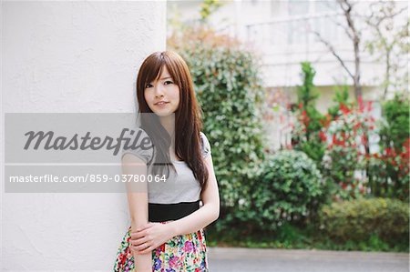 Young Girl Standing Against A Wall