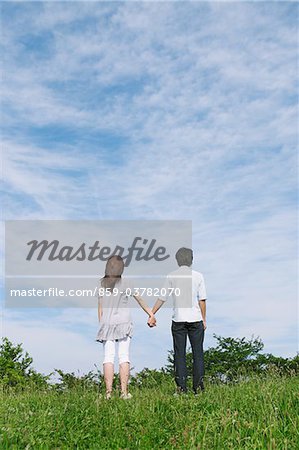 Couple Standing in Park Holding Hands