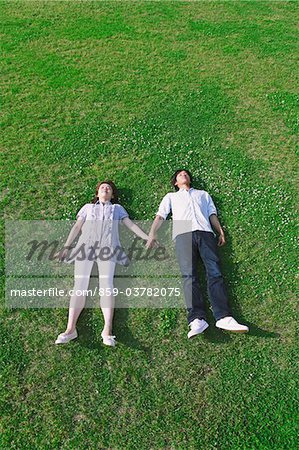 Couple Lying on Grass in Park