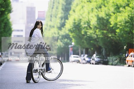 Japanese Young Woman  Smiling Sitting on Bicycle