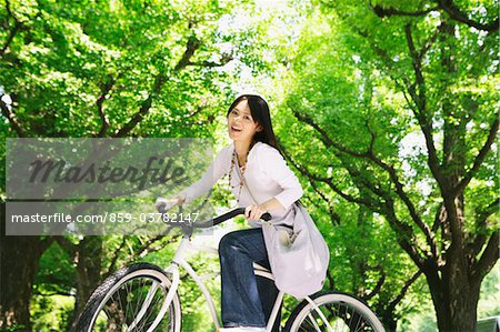 Japanese Young Woman Riding Cycle in Park