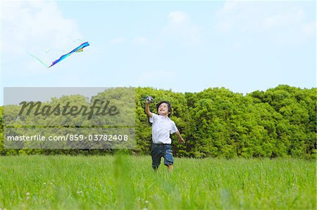 Boy Flying Kite in Park