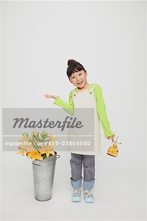 Girl Holding Spray Bottle with Bucket of Flowers