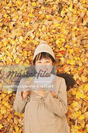 Preteen Girl Lying In Leaves
