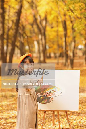 Girl Painting In Autumn Foliage