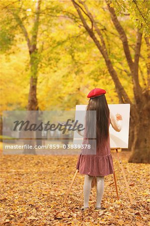 Girl Painting In Autumn Foliage