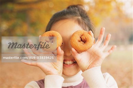 Preteen Girl Looking Trough Hole In Bagel Preteen Girl Looking Trough Hole In Bagel