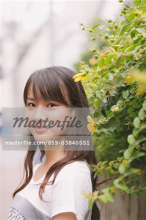 Young adult woman with yellow flower