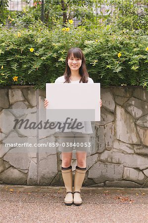 Young adult woman holding White board