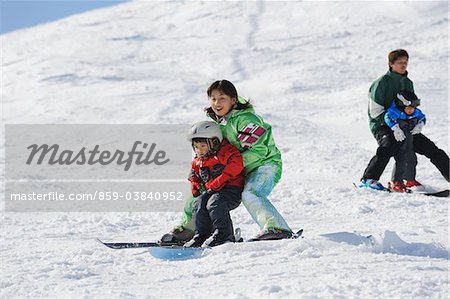 Parents Skiing With Their Son