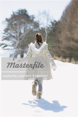 Young girl enjoying snowfall hi-res stock photography and images