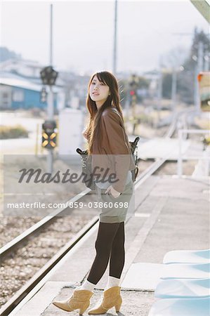 Pretty Young Woman On Platform Looking For Train