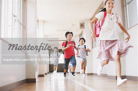 Children Running In School Corridor