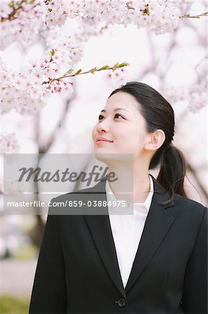 Businesswoman Standing Near Cherry Blossom Tree