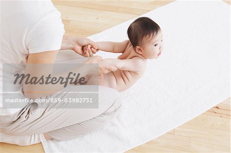 Mother Stretching Baby's Hand While Giving Massage
