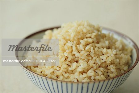 Cup of brown rice on a table