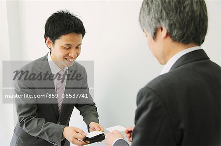 Businessmen exchanging business cards in the office