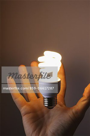Hand With Compact Fluorescent Light Bulb