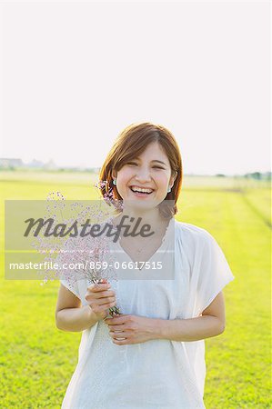 Woman Smiling With a Bouquet Of Flowers