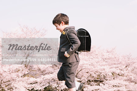 Young boy in school uniform walking