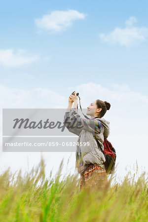 Young girl with camera on grassland